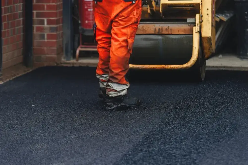 Worker On Freshly Laid Tarmac